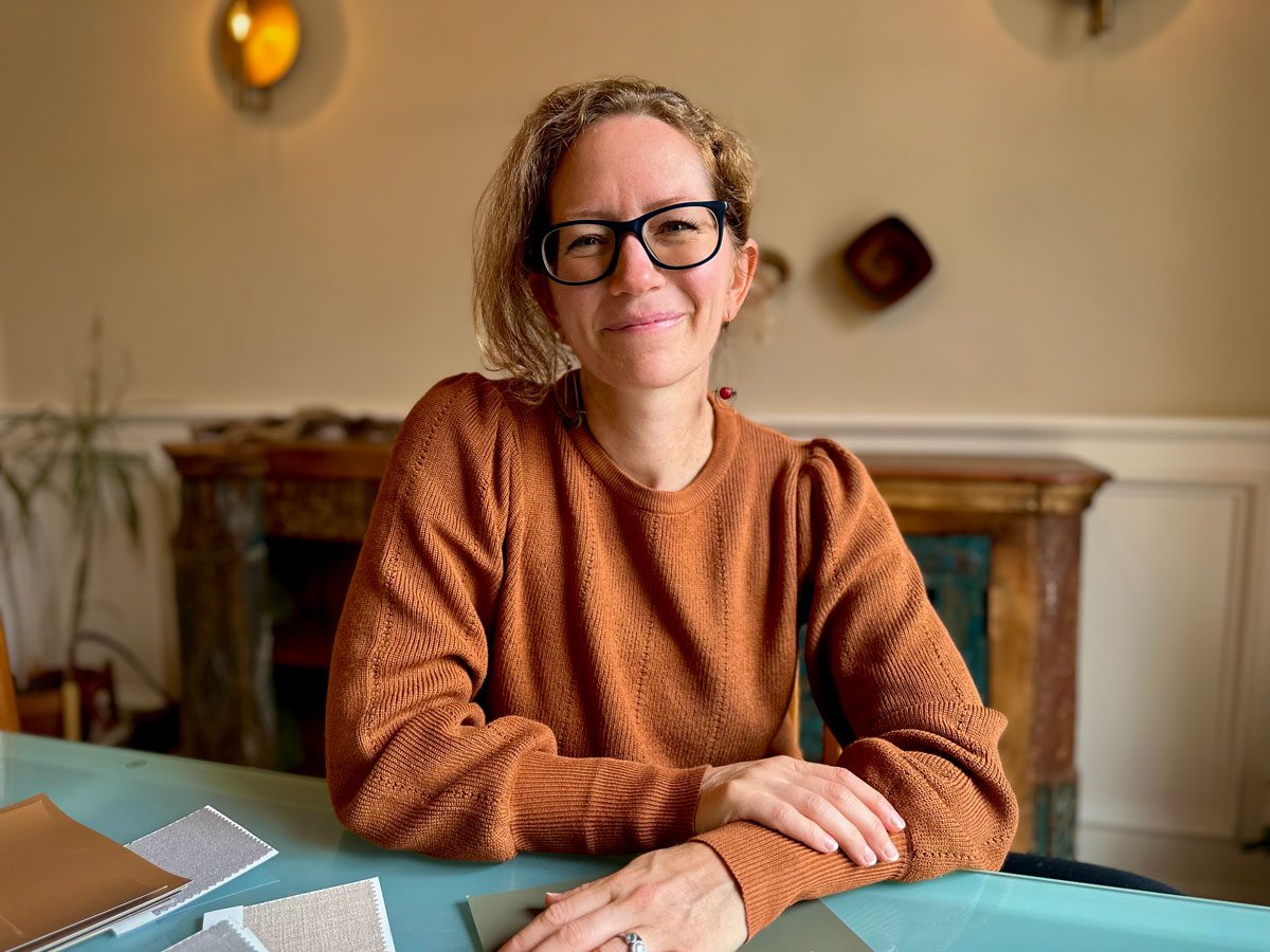 Suzie Atkin at Desk Smiling